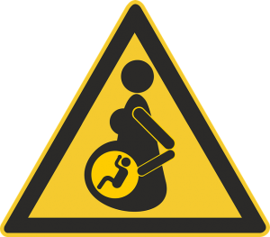 三角の注意の標識。中に妊婦と赤ちゃんのイラスト